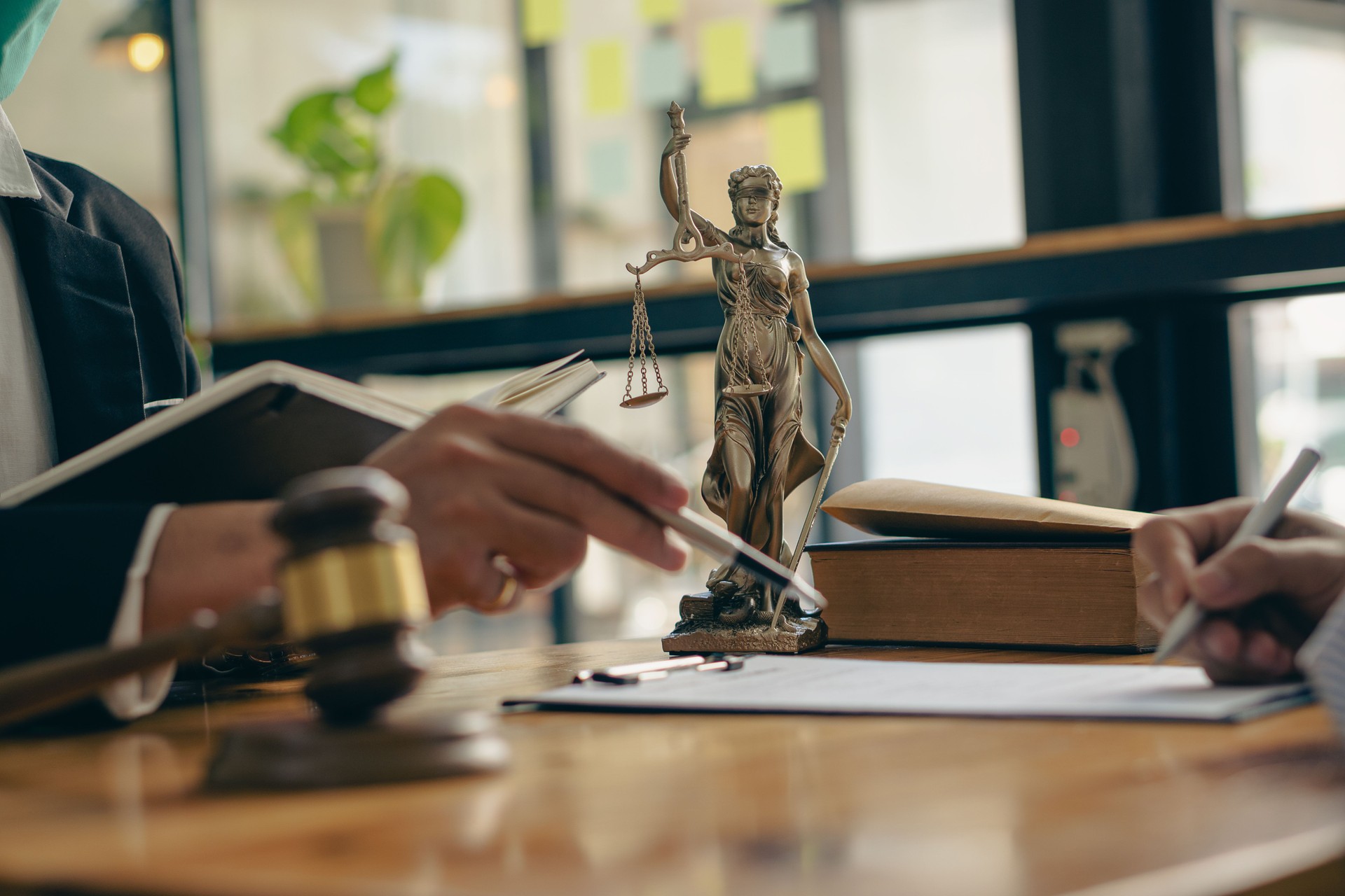 Male attorneys or judges consult teams with clients, business and legal services. The consultant presents the contract signed with the hammer placed in front and concept of justice and lawyer